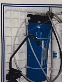 An installed AquaReject membrane unit mounted on a wall bracket with inlet, reject, and clean-water lines.
